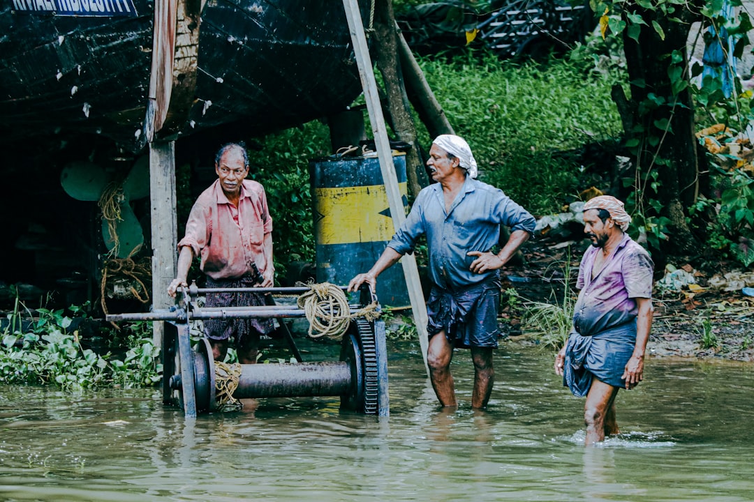 a group of people standing in a body of water