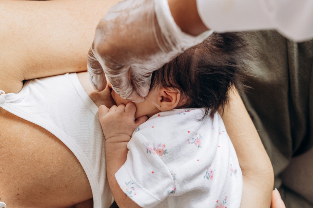 a woman is holding a baby in her arms