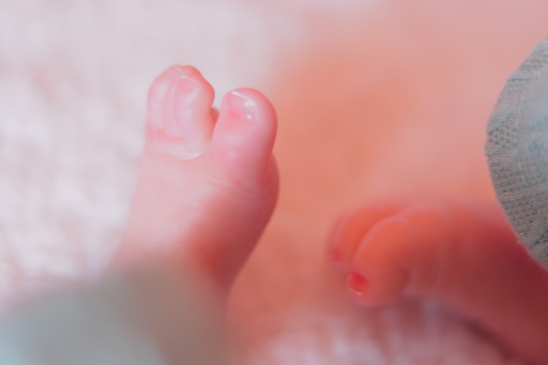 a close up of a person's foot and a baby's foot