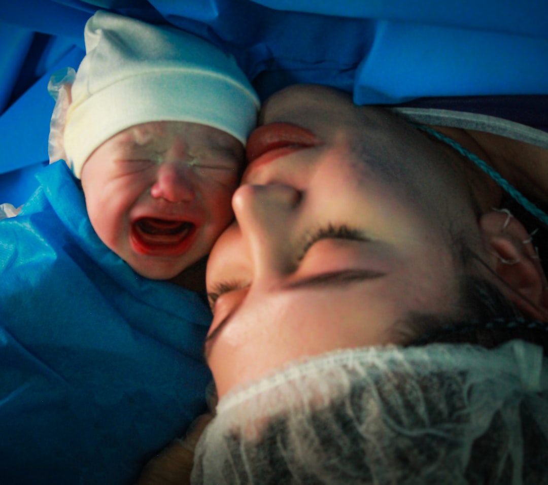 Mother and newborn share an intimate moment.