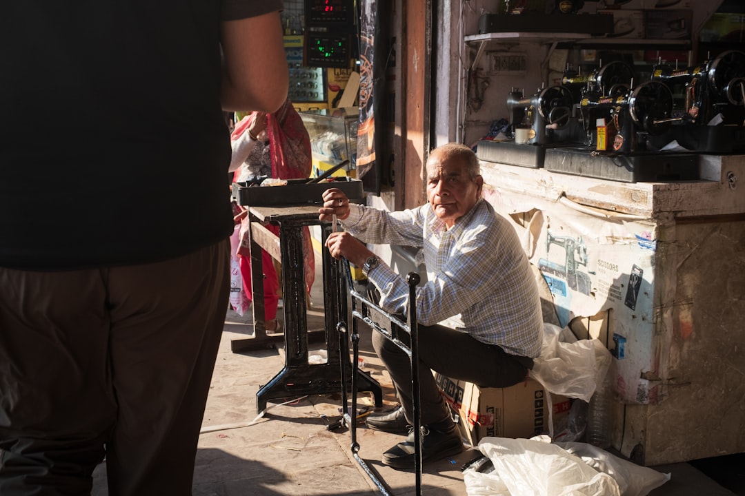A man sits outside of a store.
