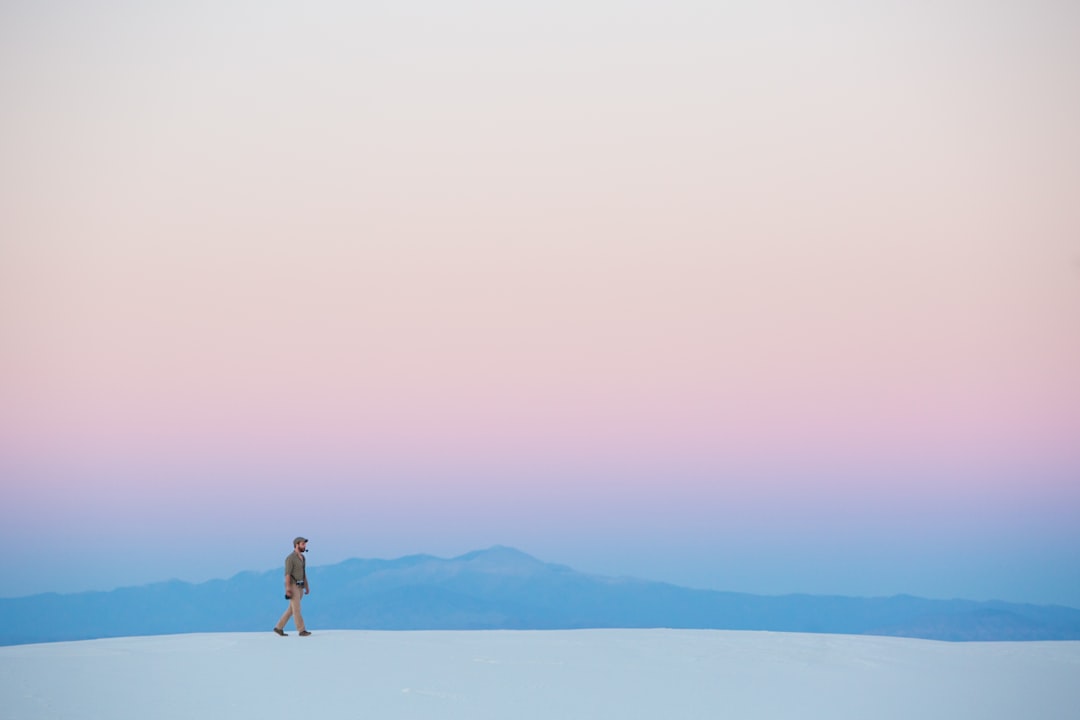 human walking on snow covered mountain