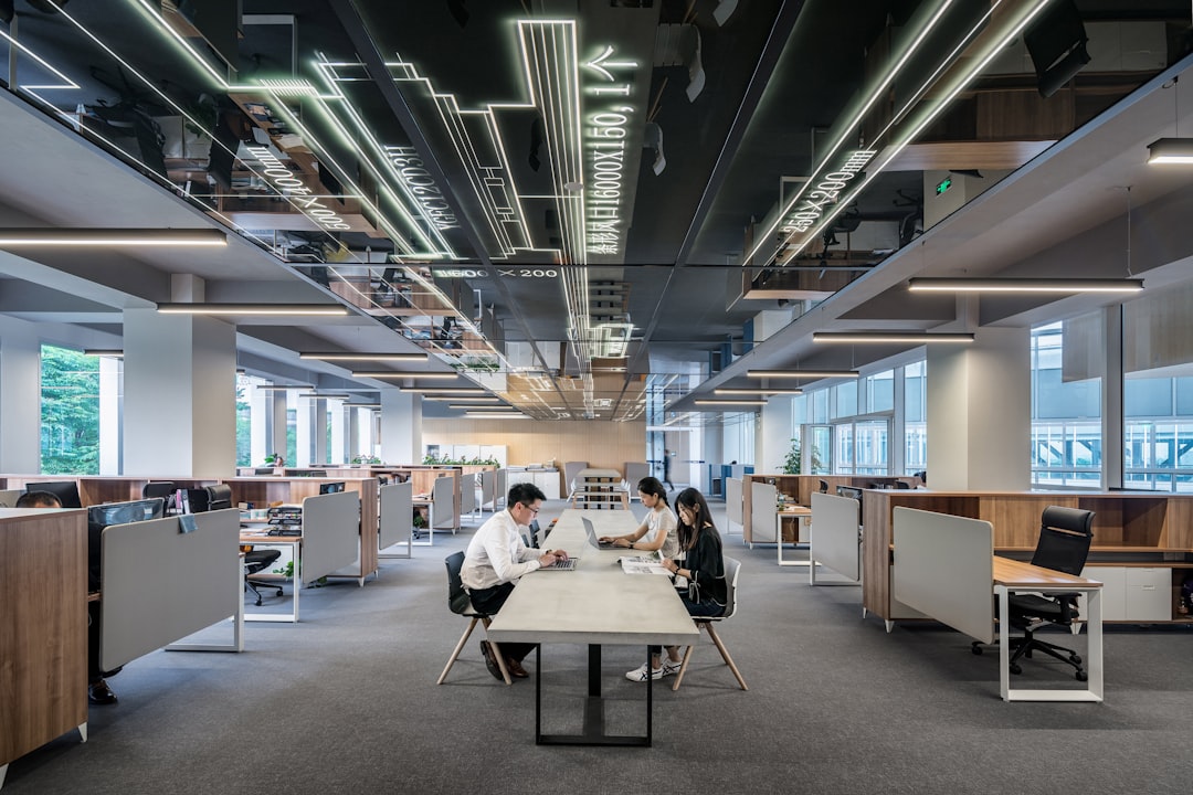 three people collaborating in open office