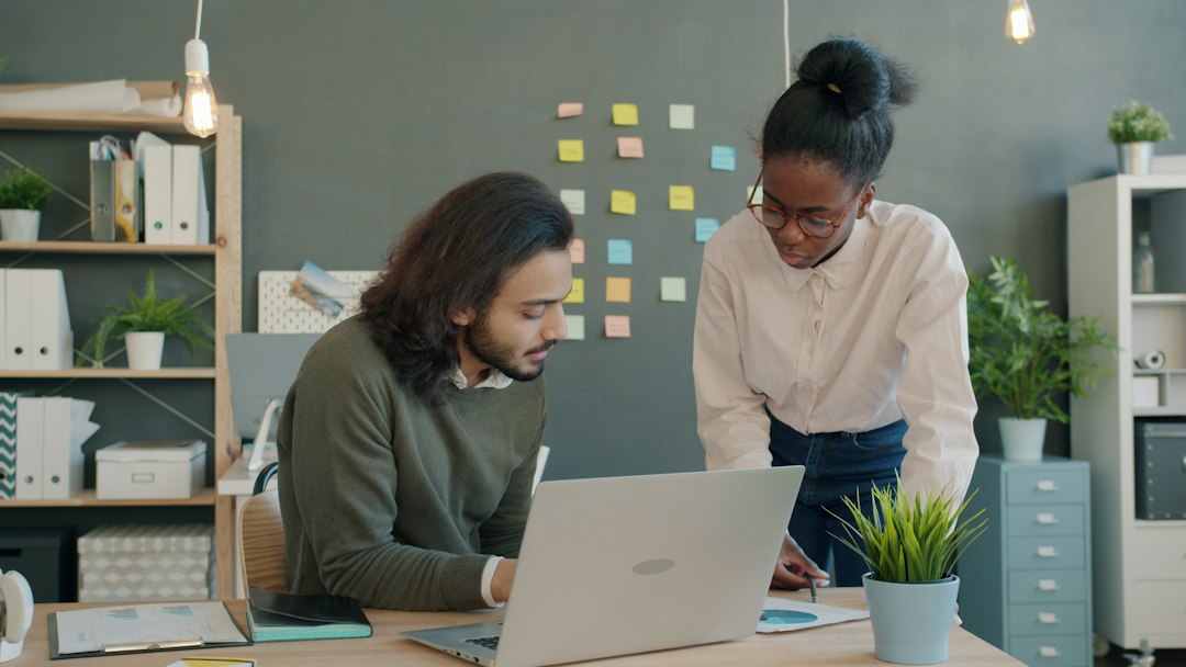 Two colleagues collaborating on a project at a desk