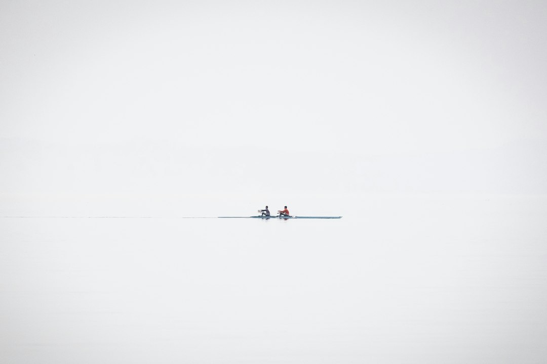 a couple of people riding on the back of a boat