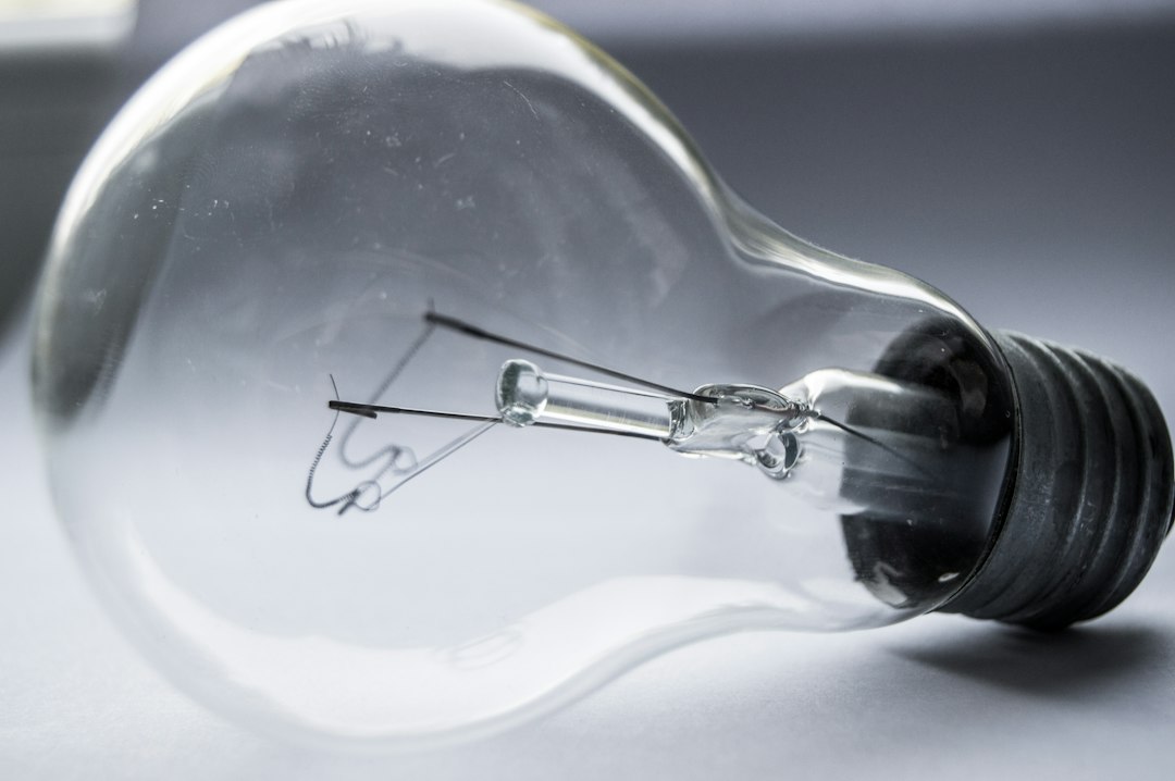 A clear glass light bulb on a gray surface