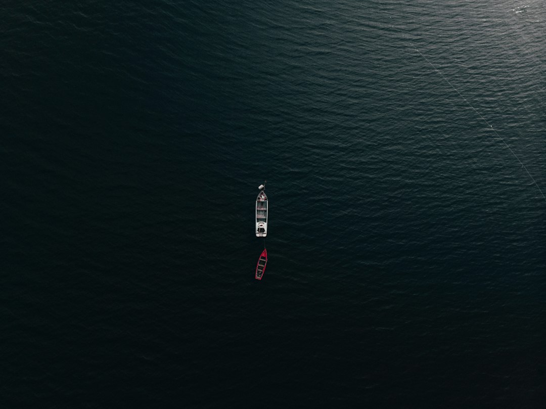 aerial view of red boat on sea during daytime